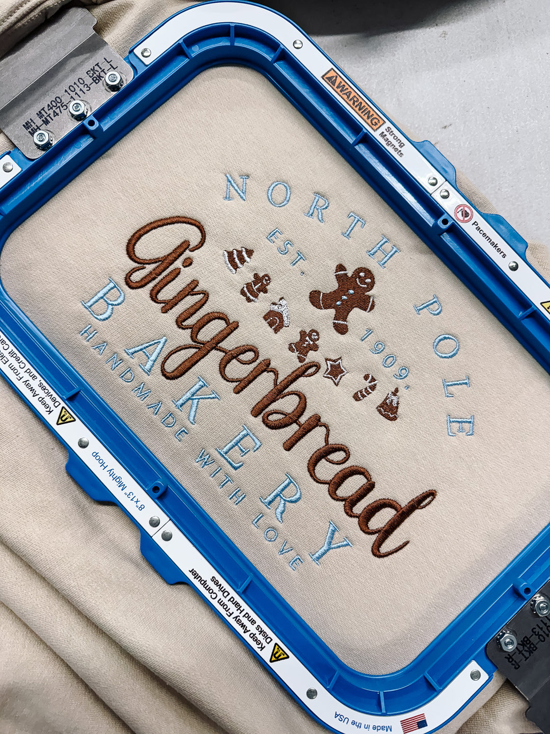 North Pole Gingerbread Bakery Embroidered Graphic Sweatshirt - Sand